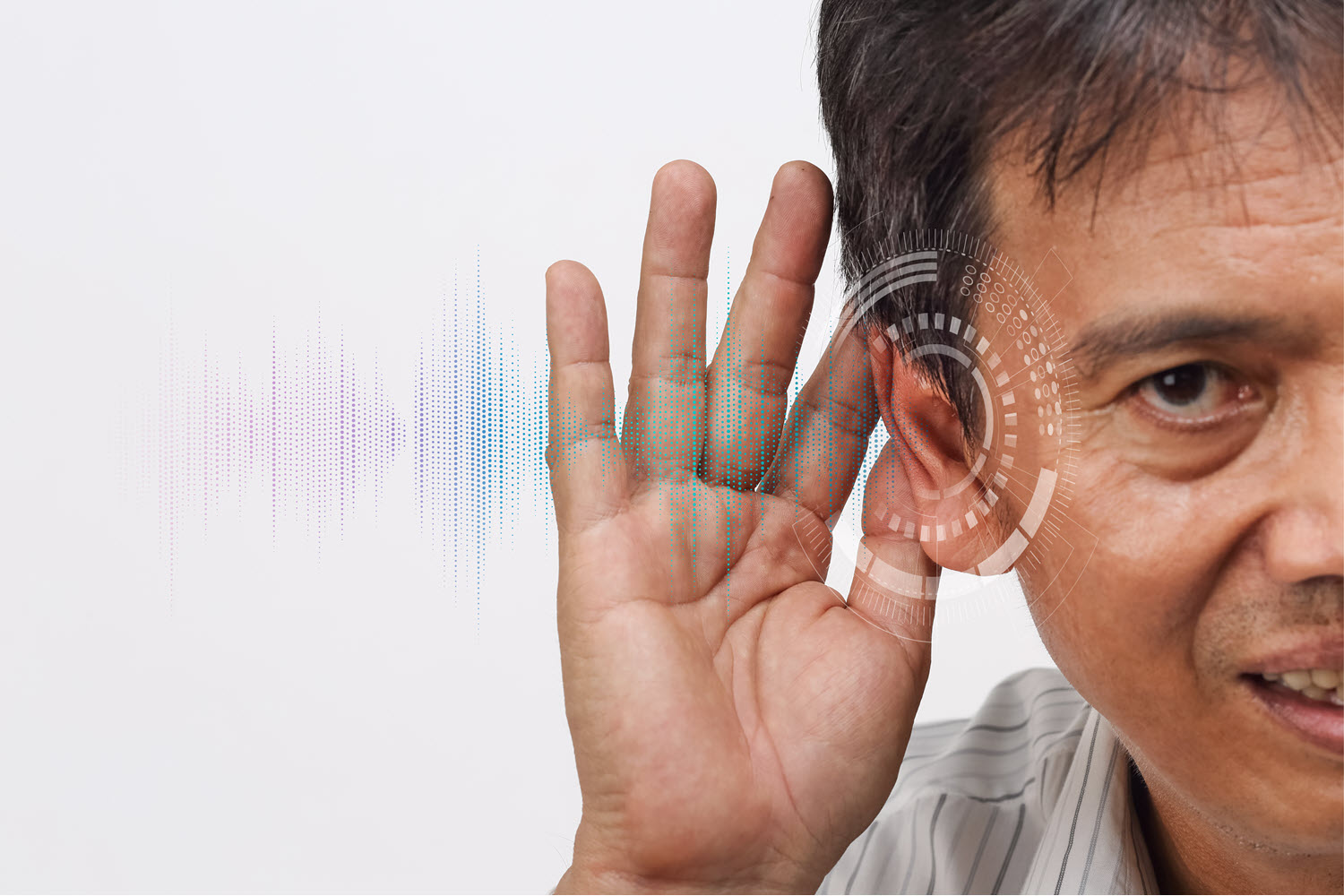 A man cupping his ear while listening